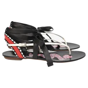 Alaïa Graphic Print Gladiator Sandals in Black Leather