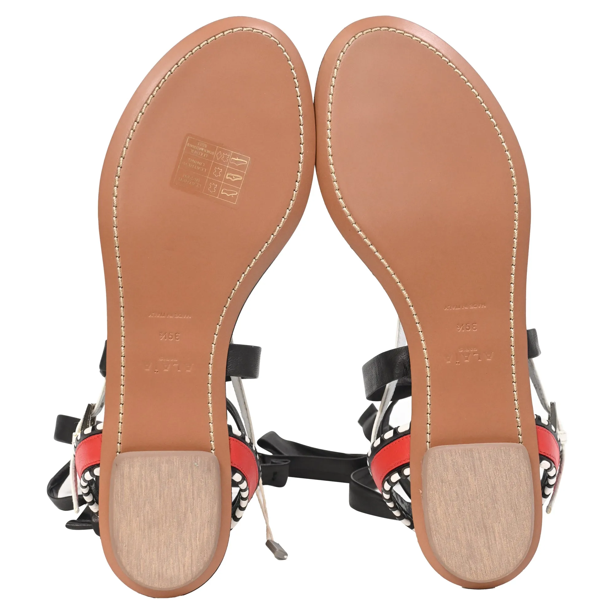 Alaïa Graphic Print Gladiator Sandals in Black Leather